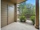 Covered patio with neutral siding and railing overlooking a landscaped area with trees and shrubs at 7489 S Quail Cir # 814, Littleton, CO 80127