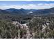 Scenic aerial view of the forested property showcasing its hillside location and abundant mature trees at 4948 Cameyo Rd, Indian Hills, CO 80454