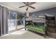 Bright bedroom features a sliding glass door to the deck with a bunk bed at 4948 Cameyo Rd, Indian Hills, CO 80454