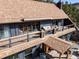 A multi-story home featuring a roof deck with outdoor seating and a welcoming front porch entrance at 4948 Cameyo Rd, Indian Hills, CO 80454