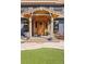 Inviting front entrance with a wooden door, charming decor and tasteful landscaping at 4948 Cameyo Rd, Indian Hills, CO 80454