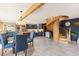 Open-concept kitchen with blue cabinets, stainless appliances, and spiral staircase to the second floor at 4948 Cameyo Rd, Indian Hills, CO 80454