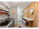 Functional laundry room with wood accents, ample shelving, and modern appliances at 4948 Cameyo Rd, Indian Hills, CO 80454