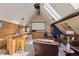 Living room with skylights, a bar area, and a cozy seating area with a large screen and home theatre projector at 4948 Cameyo Rd, Indian Hills, CO 80454