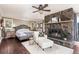 The primary bedroom features a stone fireplace, hardwood floors, and plenty of natural light at 4948 Cameyo Rd, Indian Hills, CO 80454