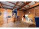 Spacious outbuilding stall with wooden walls and metal framing; ideal for storage and farm supplies at 4948 Cameyo Rd, Indian Hills, CO 80454