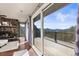 Covered deck with a view and glass doors leading to the main bedroom at 4948 Cameyo Rd, Indian Hills, CO 80454
