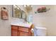 Bathroom featuring a single sink vanity and a toilet with neutral paint at 8199 W 67Th Ave, Arvada, CO 80004