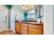 Bathroom with a double vanity, updated fixtures, and blue accent paint at 8199 W 67Th Ave, Arvada, CO 80004