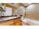 Bathroom featuring a tub, shower, toilet, and vanity with granite counters and wood cabinets at 8199 W 67Th Ave, Arvada, CO 80004