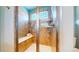 Beautifully tiled shower with built-in bench and shower head with a frosted window providing natural light at 8199 W 67Th Ave, Arvada, CO 80004
