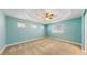 Neutral bedroom features neutral carpet, a modern ceiling fan, and multiple windows at 8199 W 67Th Ave, Arvada, CO 80004