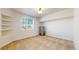 Bedroom with carpeted floors, window and shelving in a neutral color at 8199 W 67Th Ave, Arvada, CO 80004