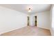 Spacious bedroom with neutral carpet, light fixture, and a walk in closet through a pair of doors at 8199 W 67Th Ave, Arvada, CO 80004