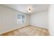 Bedroom with neutral carpet, a window to the left and a light fixture in the ceiling at 8199 W 67Th Ave, Arvada, CO 80004
