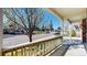 Inviting front porch with railing overlooking the neighborhood street at 8199 W 67Th Ave, Arvada, CO 80004