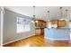 Inviting kitchen features wooden cabinets, stainless steel appliances, and a breakfast bar that seamlessly connects to the dining area at 8199 W 67Th Ave, Arvada, CO 80004