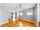 Open living room with hardwood floors, natural light, and decorative lighting fixtures at 8199 W 67Th Ave, Arvada, CO 80004