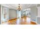 Bright living room featuring hardwood floors, modern light fixtures, and an open floor plan at 8199 W 67Th Ave, Arvada, CO 80004