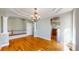 Open living area features hardwood floors, decorative columns, and neutral paint at 8199 W 67Th Ave, Arvada, CO 80004