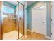 Tiled shower featuring a glass enclosure, tiled flooring, and updated fixtures at 8199 W 67Th Ave, Arvada, CO 80004