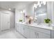 Bathroom with double sinks, quartz countertops, and a glass-enclosed shower at 3879 N Shawnee St, Aurora, CO 80019