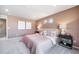 Spacious bedroom with plush carpeting, large windows, and modern decor at 3879 N Shawnee St, Aurora, CO 80019