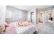 Cozy bedroom with a rainbow-themed bedspread, soft carpet, and ample natural light for a cheerful ambiance at 3879 N Shawnee St, Aurora, CO 80019
