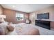 Stylish bedroom features large window, ensuite bathroom, and wall-mounted television at 3879 N Shawnee St, Aurora, CO 80019