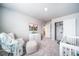 Neutral-toned Bedroom with soft carpet, a comfortable rocking chair, and mountain-themed decor at 3879 N Shawnee St, Aurora, CO 80019