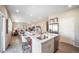 Open-concept kitchen featuring an island, stainless steel appliances, and an adjoining living area at 3879 N Shawnee St, Aurora, CO 80019