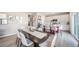 Spacious dining area that transitions to an open kitchen concept with an island and modern finishes at 3879 N Shawnee St, Aurora, CO 80019