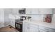 Modern kitchen with stainless steel appliances, sleek countertops, and white cabinetry at 3879 N Shawnee St, Aurora, CO 80019