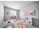Bright playroom featuring a vibrant rug, table, chairs, toy kitchen, and art, ideal for creative play at 3879 N Shawnee St, Aurora, CO 80019