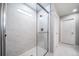 Glass-enclosed shower features white marble tile and a rain shower head at 3879 N Shawnee St, Aurora, CO 80019