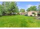 Spacious backyard with mature trees and shrubs, offering ample space for outdoor activities and landscaping opportunities at 7442 S Wellington St, Centennial, CO 80122