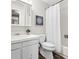 Neat bathroom featuring a shower/tub, toilet, and vanity with storage at 7442 S Wellington St, Centennial, CO 80122