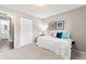 Simple bedroom with white closet doors and access to the bathroom at 7442 S Wellington St, Centennial, CO 80122