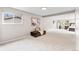 Spacious bedroom with neutral carpet, artwork, and cozy seating with natural light at 7442 S Wellington St, Centennial, CO 80122