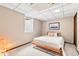 Comfortable bedroom with a window, and a cozy bed, under a tiled ceiling with neutral walls and carpet at 7442 S Wellington St, Centennial, CO 80122