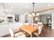 Dining area leading to a modern kitchen with stainless steel appliances and bright white cabinetry at 7442 S Wellington St, Centennial, CO 80122