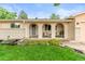 Charming brick home featuring an inviting front porch with arched openings and seating area at 7442 S Wellington St, Centennial, CO 80122