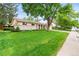 Charming single-story home with a lush, green front lawn and mature shade trees at 7442 S Wellington St, Centennial, CO 80122