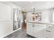 Eat-in kitchen featuring stainless steel refrigerator, granite countertops, and white cabinets and drawers at 7442 S Wellington St, Centennial, CO 80122