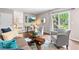 Open-concept living room with backyard access and views into the kitchen and dining area at 7442 S Wellington St, Centennial, CO 80122