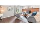 Cozy living room with hardwood floors, fireplace, mantle, and neutral furniture at 7442 S Wellington St, Centennial, CO 80122