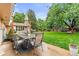 Outdoor patio with dining set and string lights, perfect for enjoying the lush backyard at 7442 S Wellington St, Centennial, CO 80122
