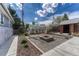 Landscaped backyard featuring a greenhouse, shed, and gravel area with a fire pit, perfect for outdoor entertaining at 7541 Julian St, Westminster, CO 80030