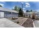 Well-maintained backyard with a fire pit and a greenhouse perfect for relaxation and gardening at 7541 Julian St, Westminster, CO 80030