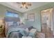 Charming bedroom featuring an upholstered headboard, bench, ceiling fan, and wood-look flooring at 7541 Julian St, Westminster, CO 80030